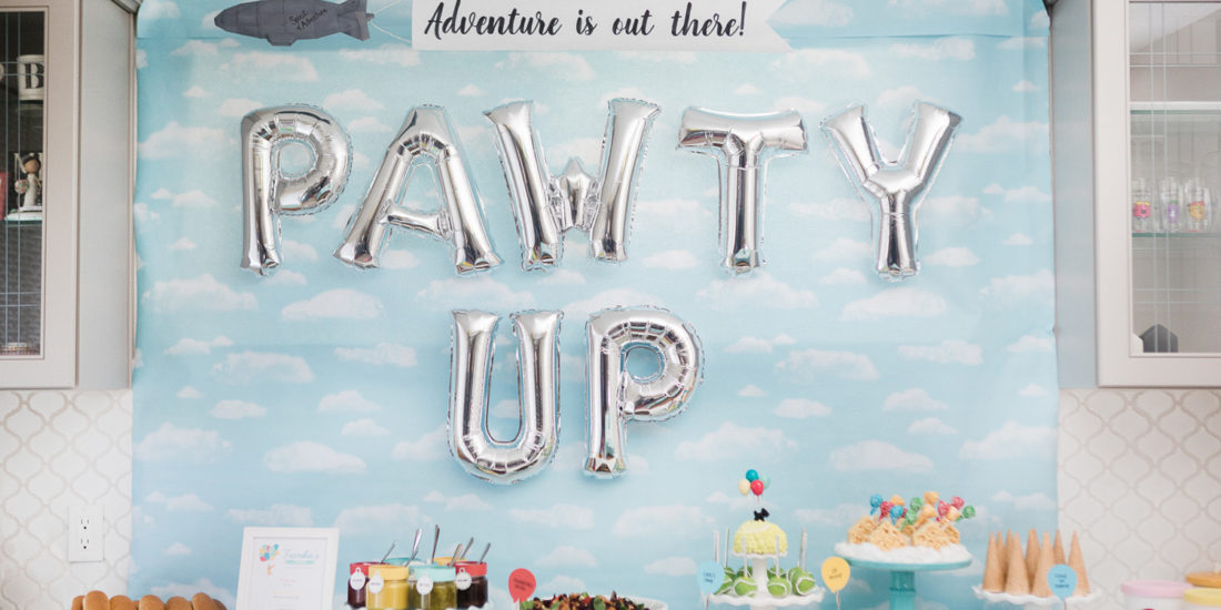 Pixar Up food table with cloud backdrop and "PAWTY UP" balloons