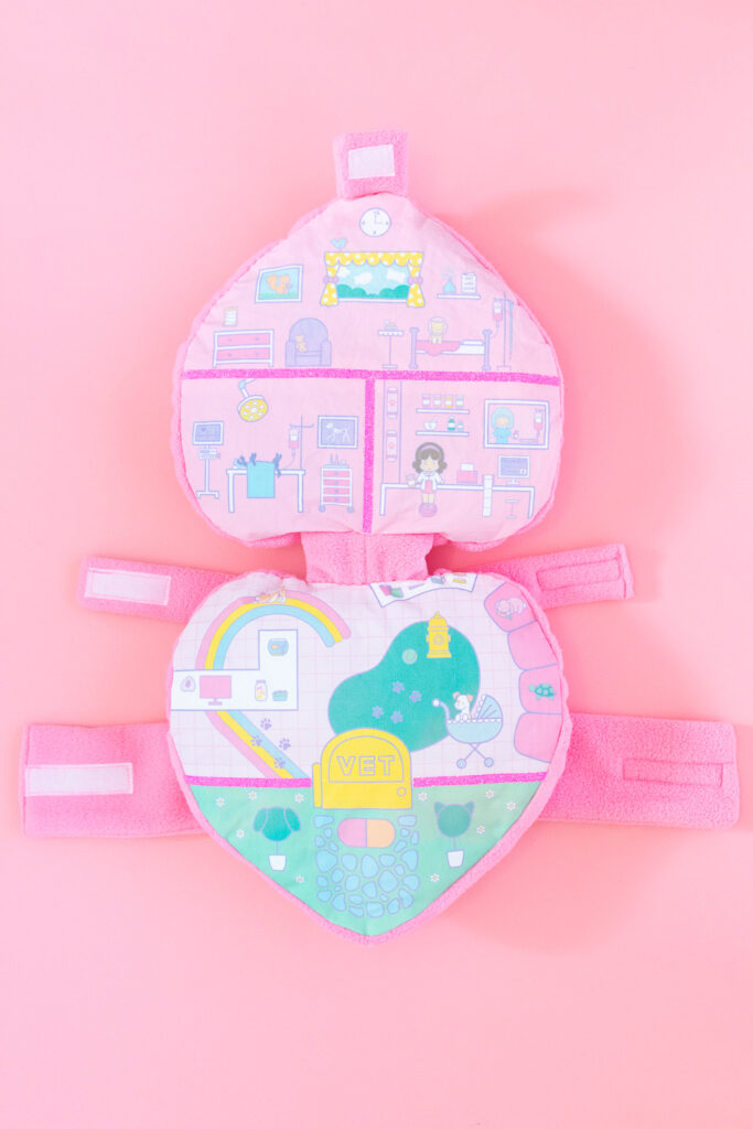 The inside of a Polly Pocket dog costume featuring an illustration of a pet hospital.