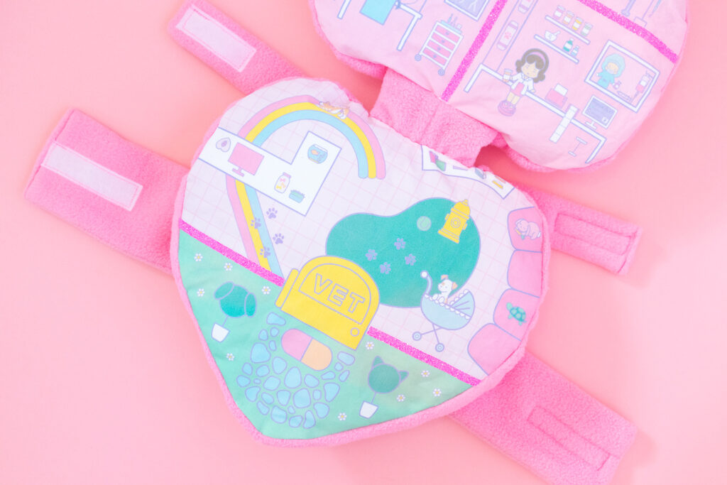 The bottom half of a Polly Pocket dog costume featuring an illustration of a pet hospital. 